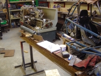  more designing of how the ram will be mounted and the dimensions of the cutting knife. New lathe in the background.